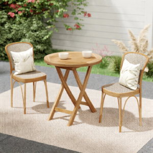 Teak folding table on patio with two small white bowls and chairs on top of an creme colored outdoor carpet.
